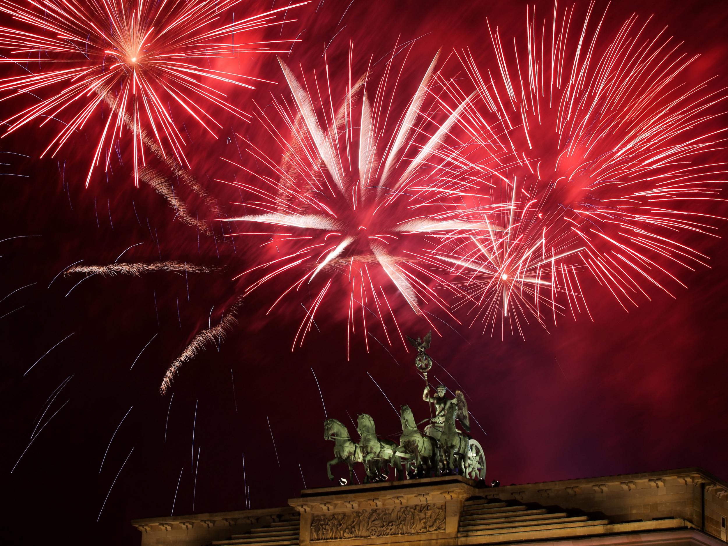 Fireworks explode behind the Quadriga statue of the Brandenburg Gate on the occasion of New Year's Eve celebrations in Berlin
