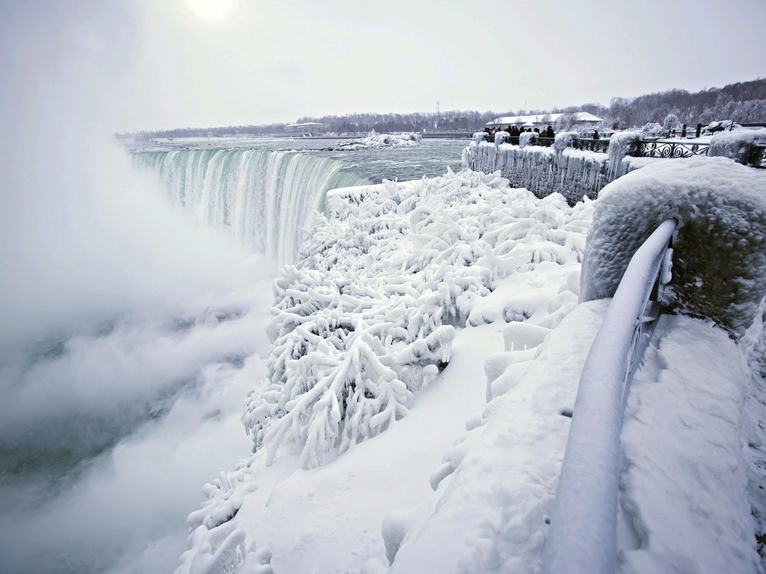 Visitors take photographs at the brink of the Horseshoe Falls