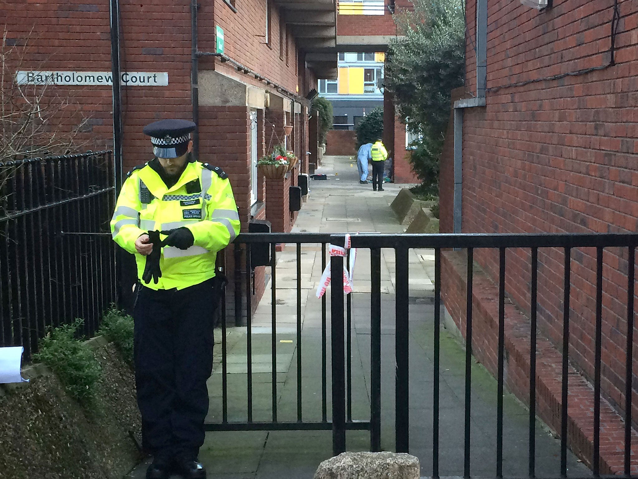 Police and forensic officers at the scene of a stabbing at Bartholomew Court, near Old Street in London