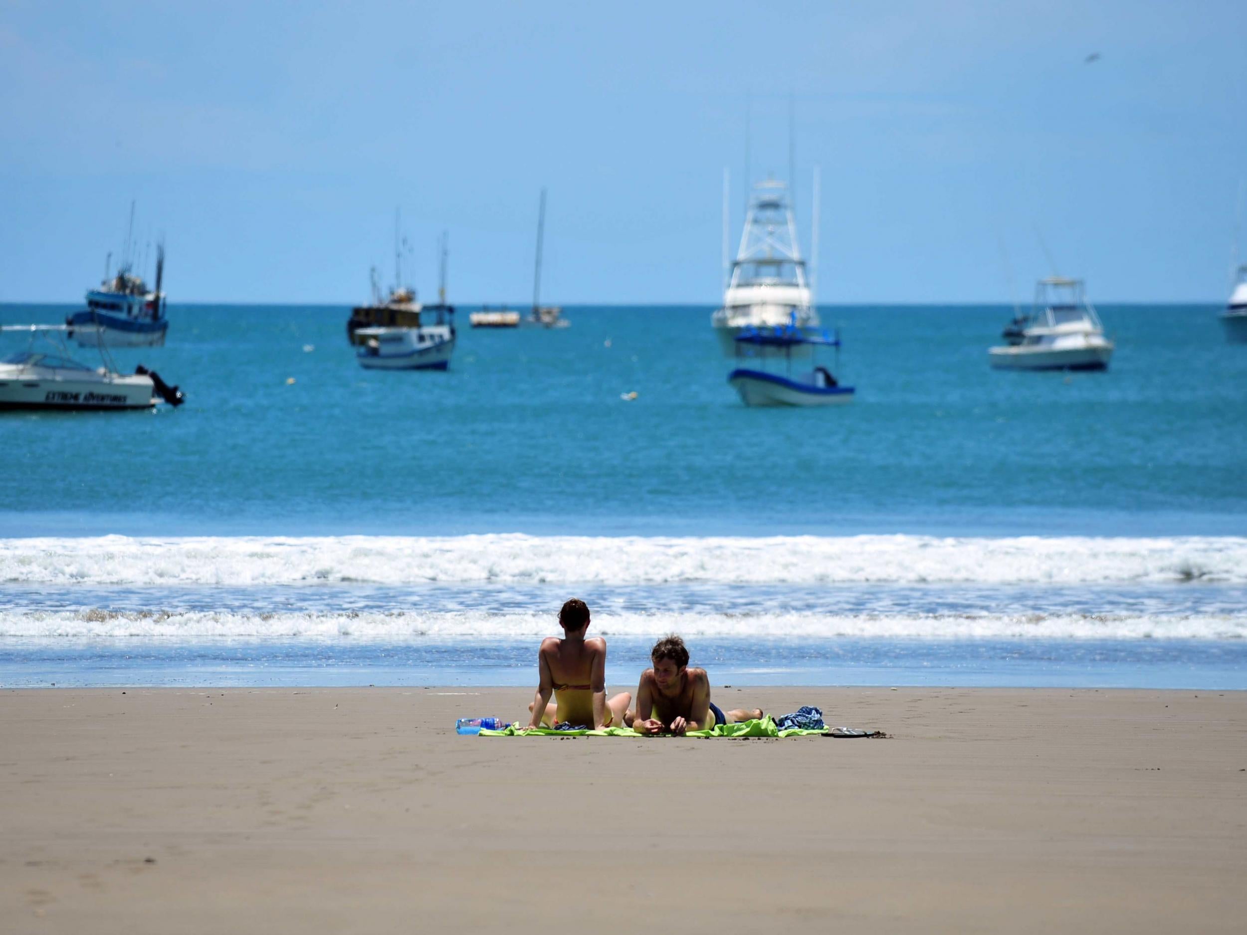 Tourists enjoy the Pacific ocean on San Juan del Sur beach, 140 km from Managua, Costa Rica