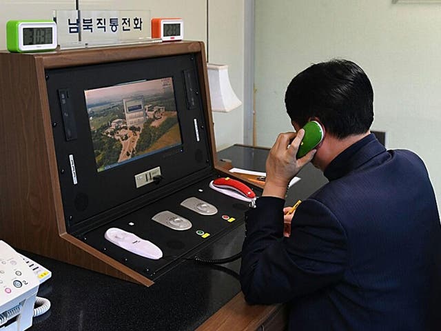 A South Korean government official checks the direct communications hotline to talk with the North Korean side at the border village of Panmunjom