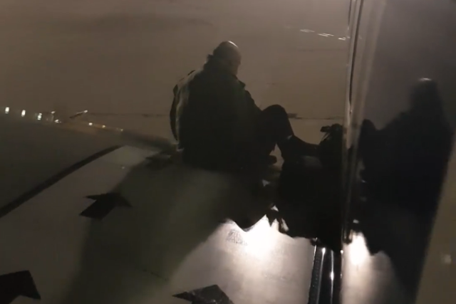 A passenger went and sat on the wing after their flight was delayed