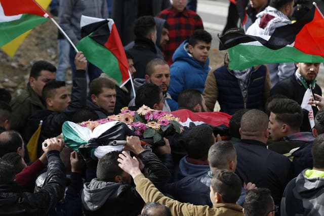 Palestinian mourners carry the body of Musab Firas al-Tamimi, 17, who was shot dead in clashes with the Israeli army a day earlier, during his funeral in the village of Deir Nizam north of Ramallah in the occupied West Bank, on 4 January 2018