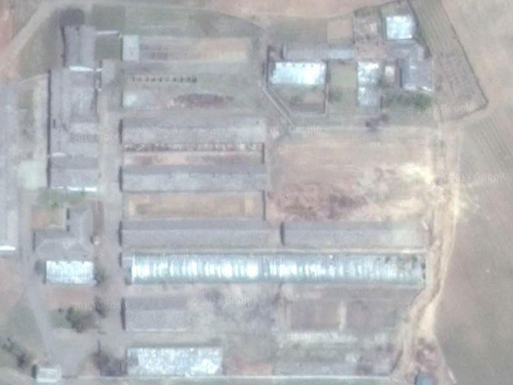 Satellite images taken after the test show a cleared area where a building once stood (centre right) and damage to a greenhouse, beneath the cleared area