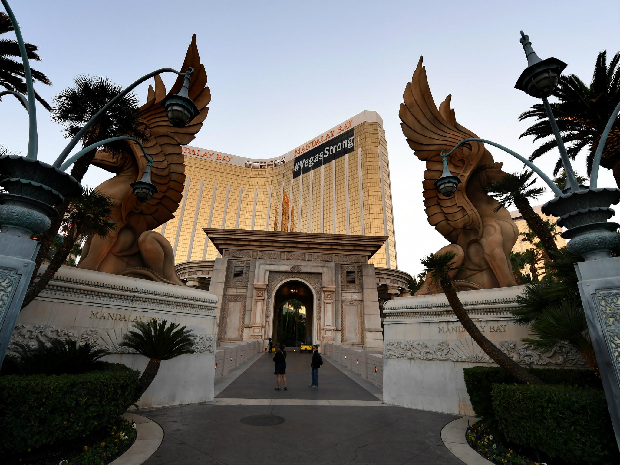 The Mandalay Hotel with a 'Vegas Strong' banner near the repaired windows of the shooter' s room, next to the scene of the worst shooting in US history
