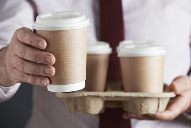 Businessman Holding Tray Of Takeaway Coffee