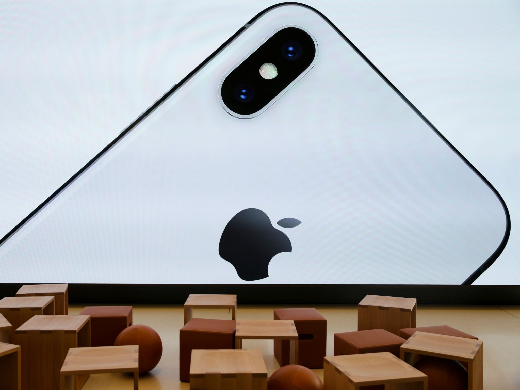 An iPhone X is seen on a large video screen in the new Apple Visitor Center in Cupertino, California