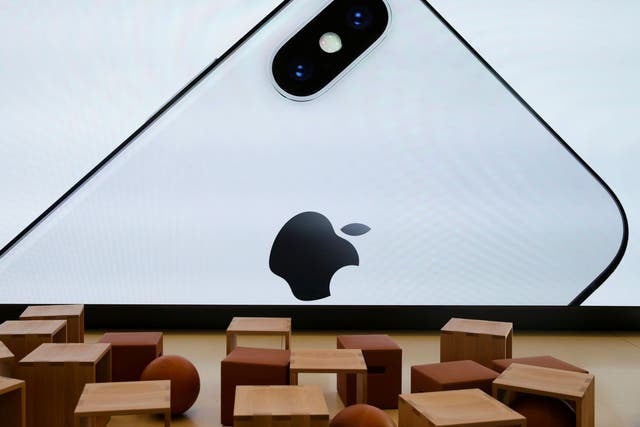 An iPhone X is seen on a large video screen in the new Apple Visitor Center in Cupertino, California