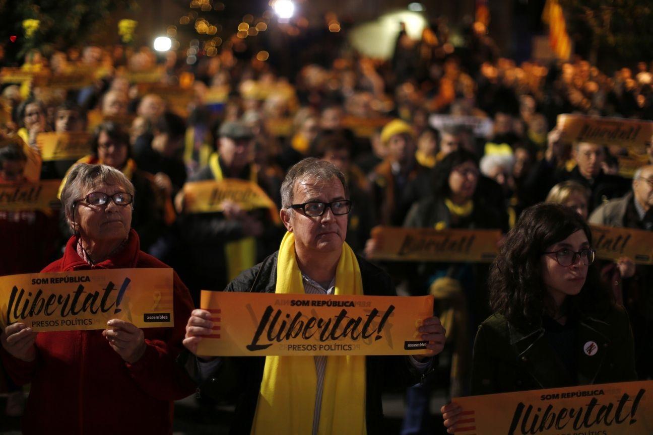 Demonstrators hold banners reading "freedom for the political prisoners" during a protest in support of jailed Catalan politicians