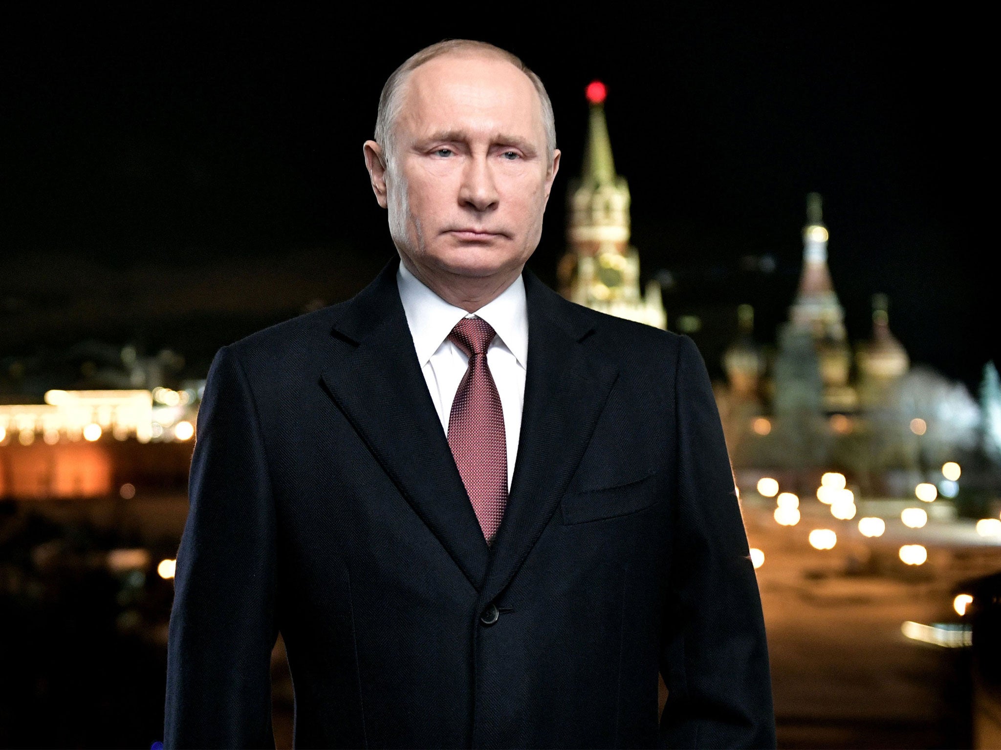 Vladimir Putin standing in front of the Kremlin to deliver his annual New Year address to the nation