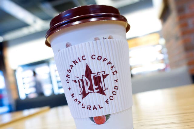 A disposable coffee cup with a plastic lid is pictured inside a branch of Pret A Manger in London