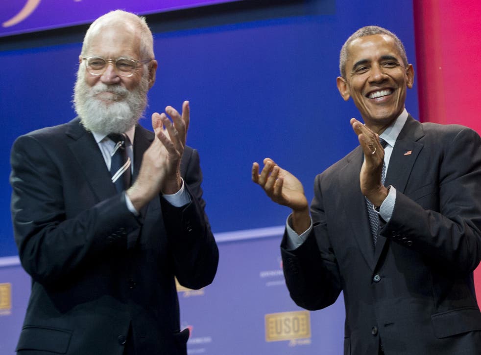 US President Barack Obama applauds alongside former talk show host David Letterman during a celebration of the 5th anniversary of Joining Forces and the 75th anniversary of the USO at Andrews Air Force Base in Maryland, May 5, 2016. Credit: SAUL LOEB/AFP/