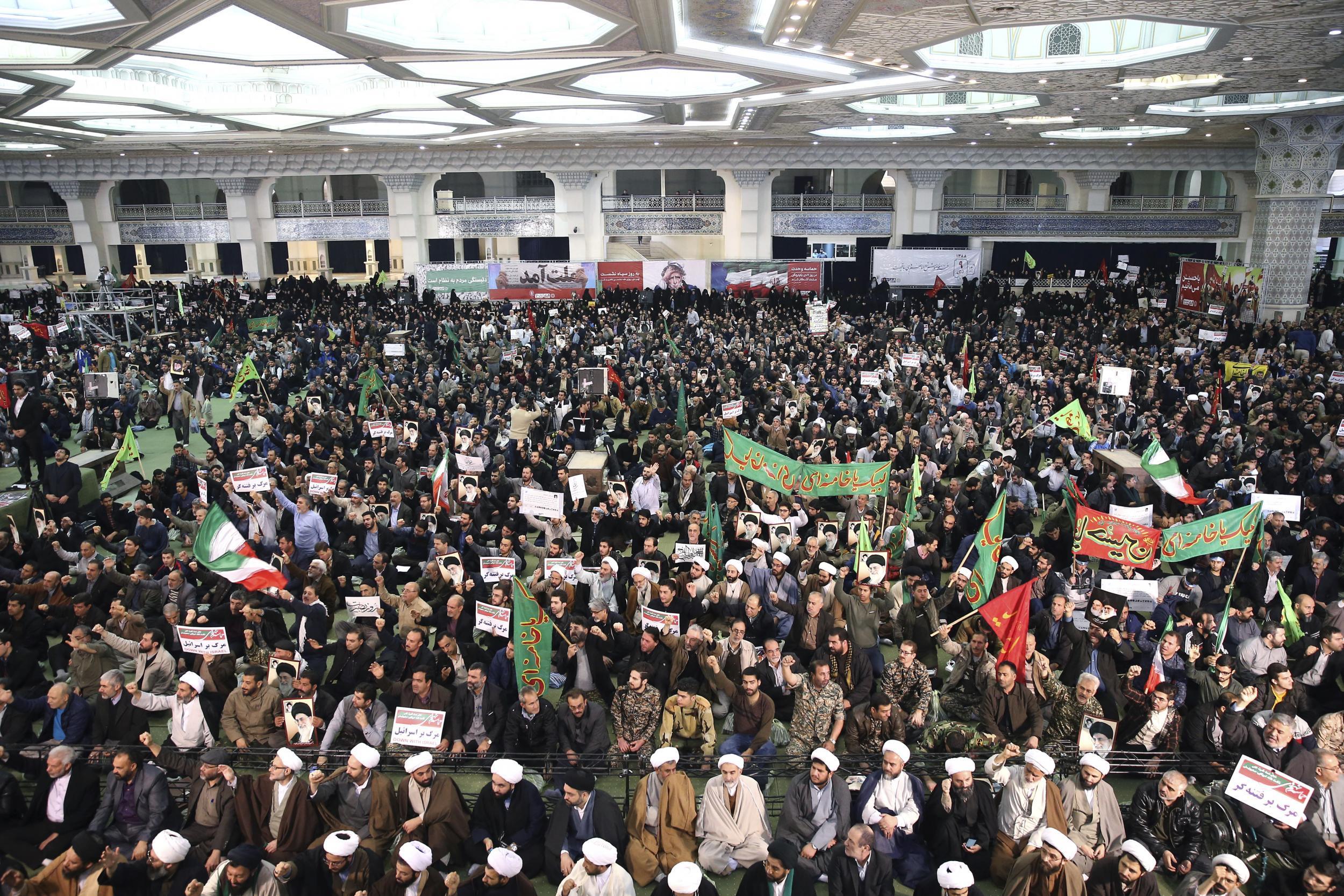 Iranian protesters chant slogans at a rally in Tehran, Iran