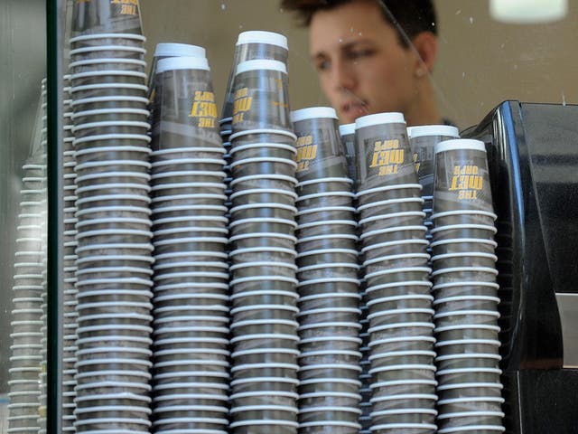 Take-away coffee cups are displayed alongside a coffee machine at the 'Met Cafe', one of the most popular cafes in the central business district of Sydney on April 20, 2010.