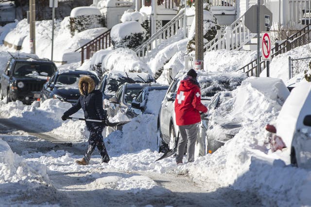 Residents in Boston, Massachusetts shovel out their vehicle the day after the region was hit with a 'bomb cyclone'