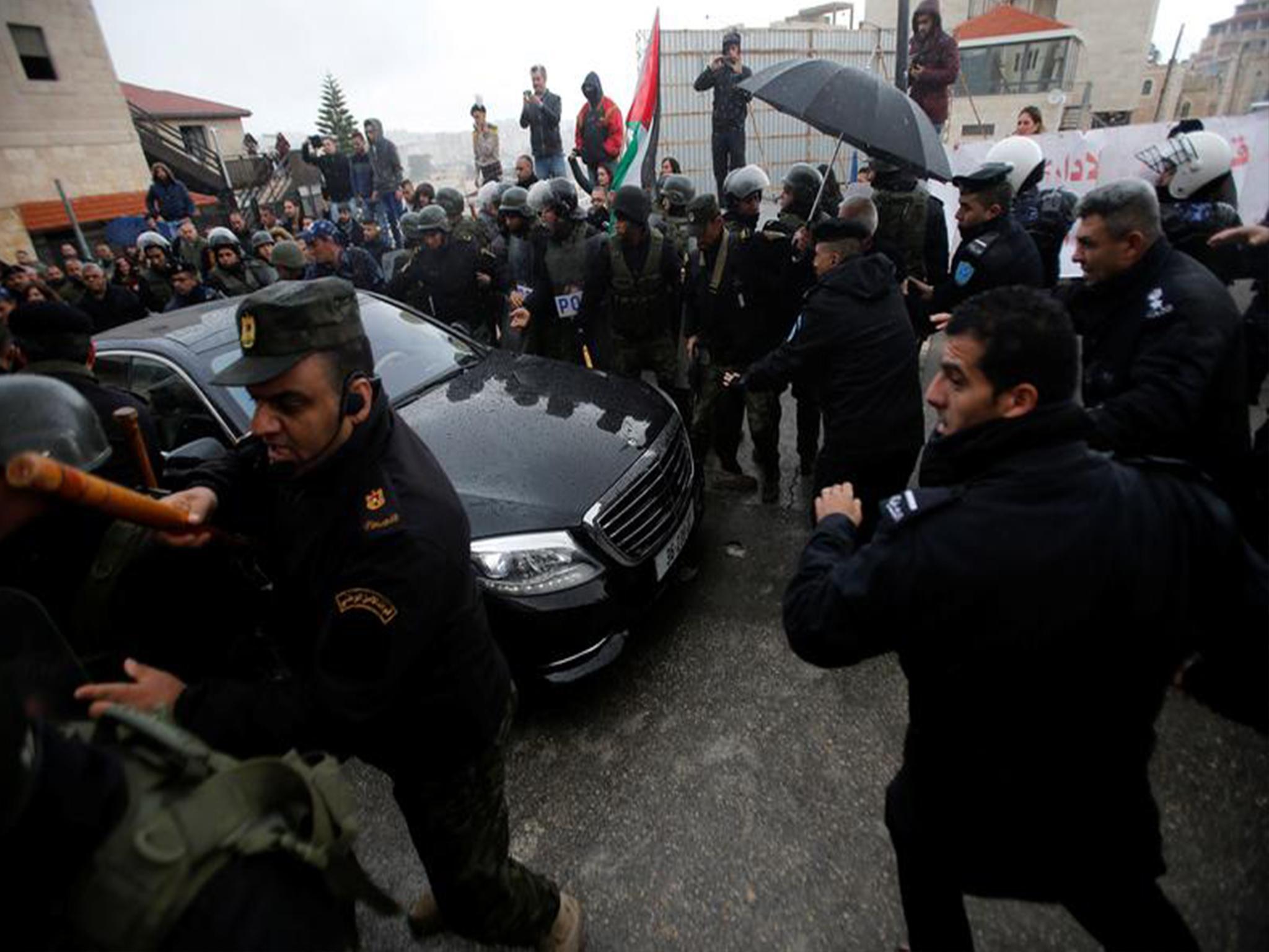 Security forces were present and were seen pushing demonstrators away
