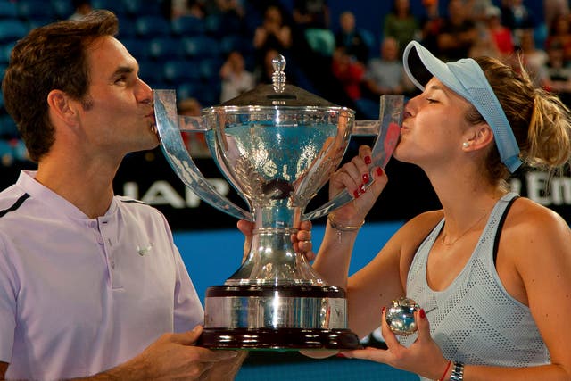 Roger Federer and Belinda Bencic celebrate with the trophy
