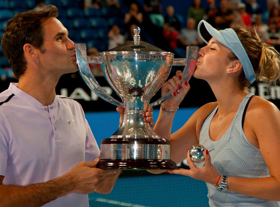 Roger Federer and Belinda Bencic celebrate with the trophy
