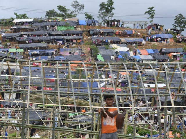 Rohingya refugees build a makeshift shelter at a refugee camp near the Bangladeshi village of Gumdhum