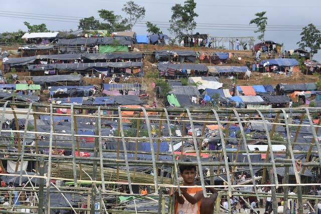 Rohingya refugees build a makeshift shelter at a refugee camp near the Bangladeshi village of Gumdhum