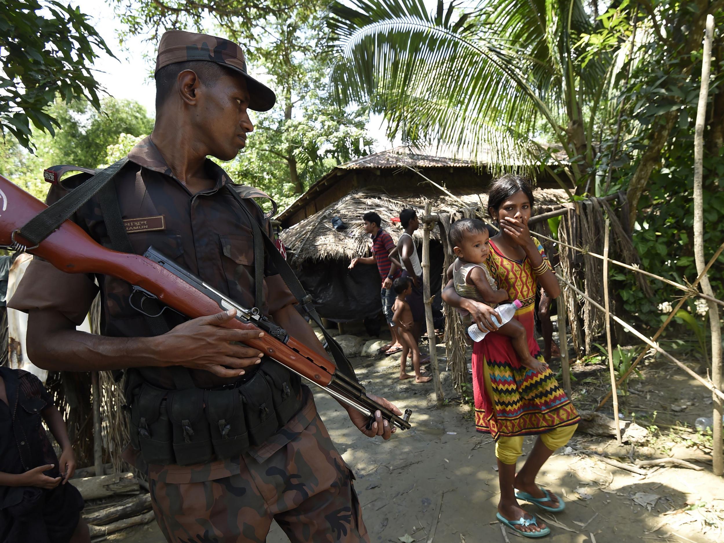 A Bangladeshi border guard stands watch at a camp in the no man's land on the border with Myanmar