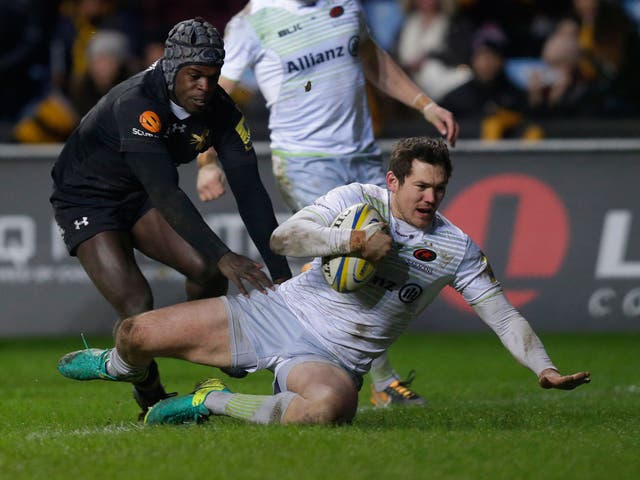 Alex Goode dives over for his first try of the match