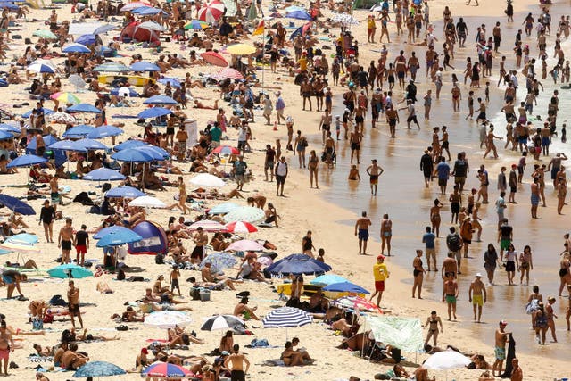 People crowd the beach on Bondi beach in Sydney, Australia