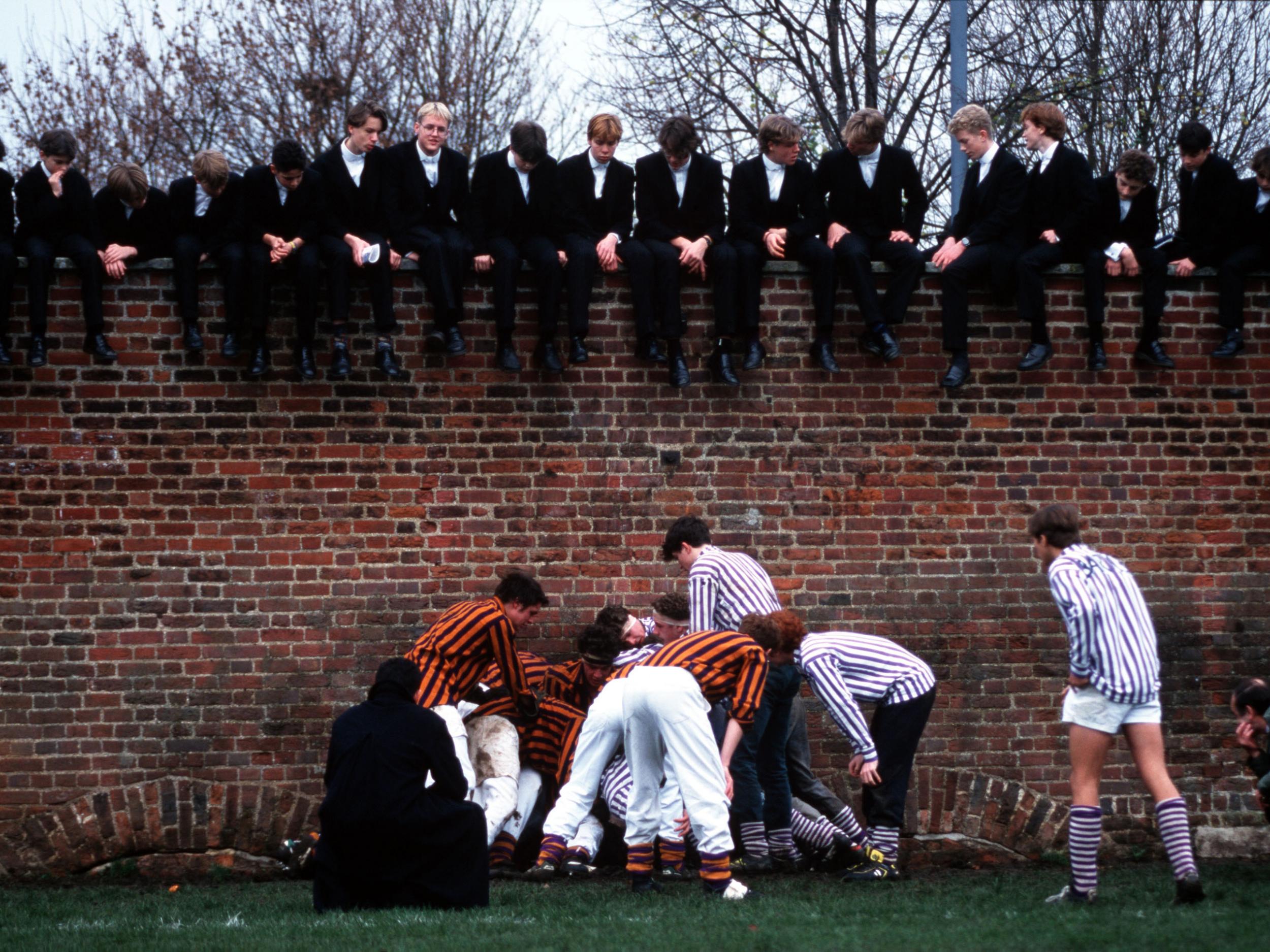 Public school boys are pictured playing the traditional Eton Wall Game.