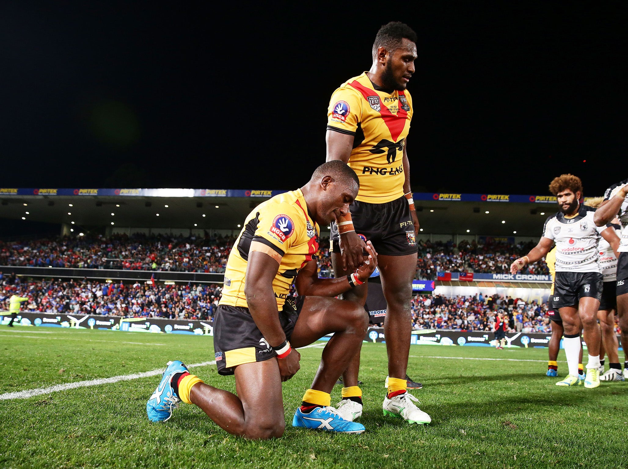 Kato Ottio, standing, played for Papua New Guinea in the Rugby League World Cup