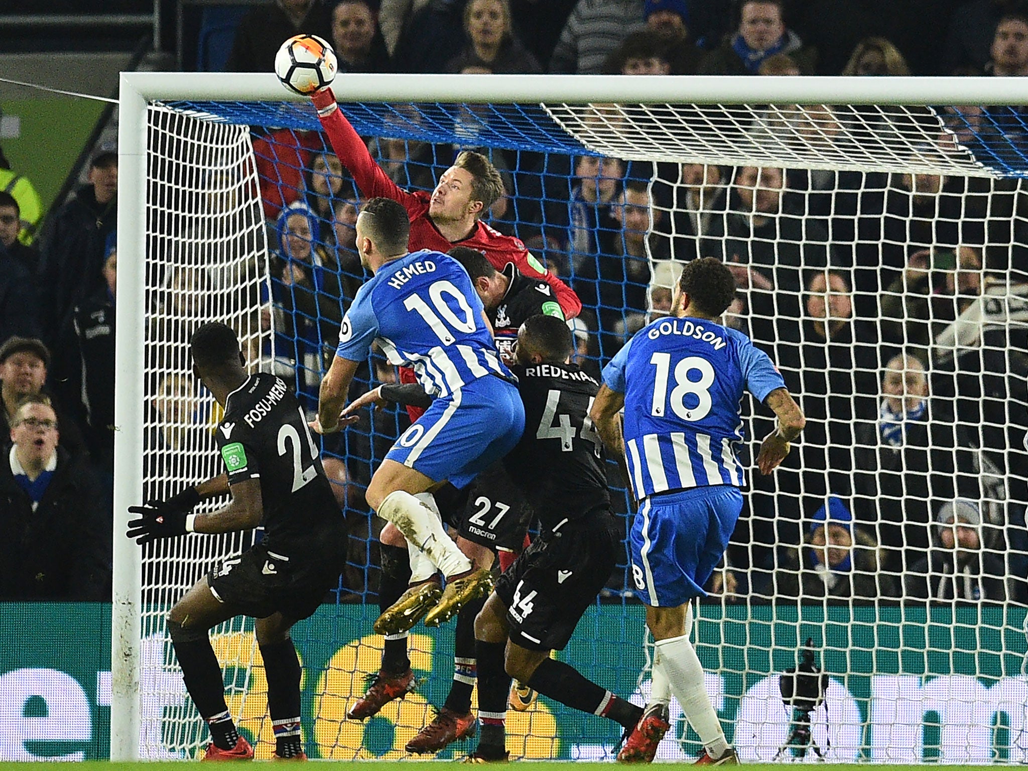 Wayne Hennessey asserts himself to punch clear a Brighton delivery