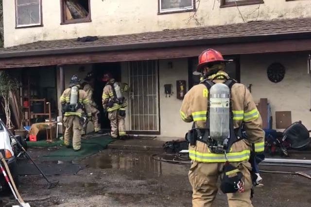 Firefighters in the aftermath of an apartment fire in the Californian city of Redding