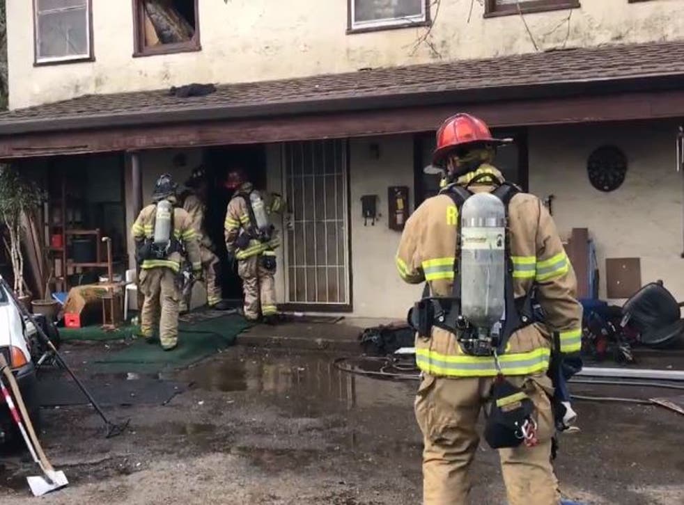 Firefighters in the aftermath of an apartment fire in the Californian city of Redding