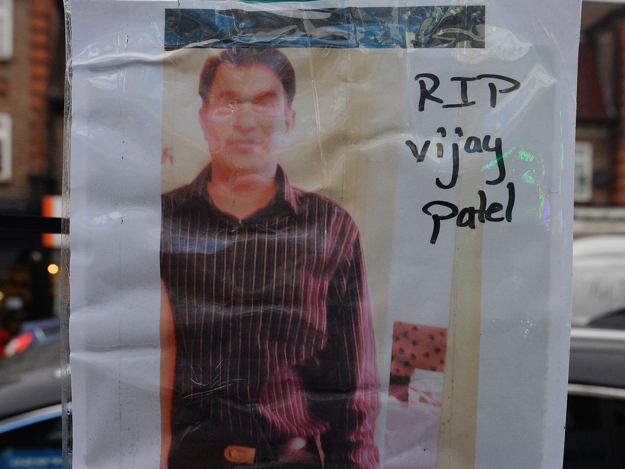 A photograph of Vijay Patel, 49, outside the shop where he was killed on The Broadway in Mill Hill, north London