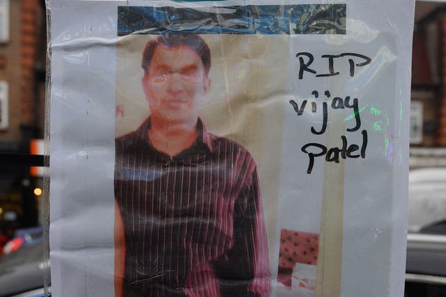 A photograph of Vijay Patel, 49, outside the shop where he was killed on The Broadway in Mill Hill, north London