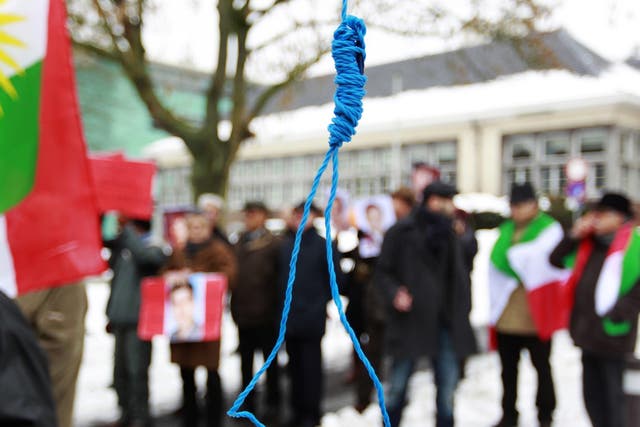 Iranian exiles shout slogans in front of a mock gallows during a demonstration in Brussels in 2010