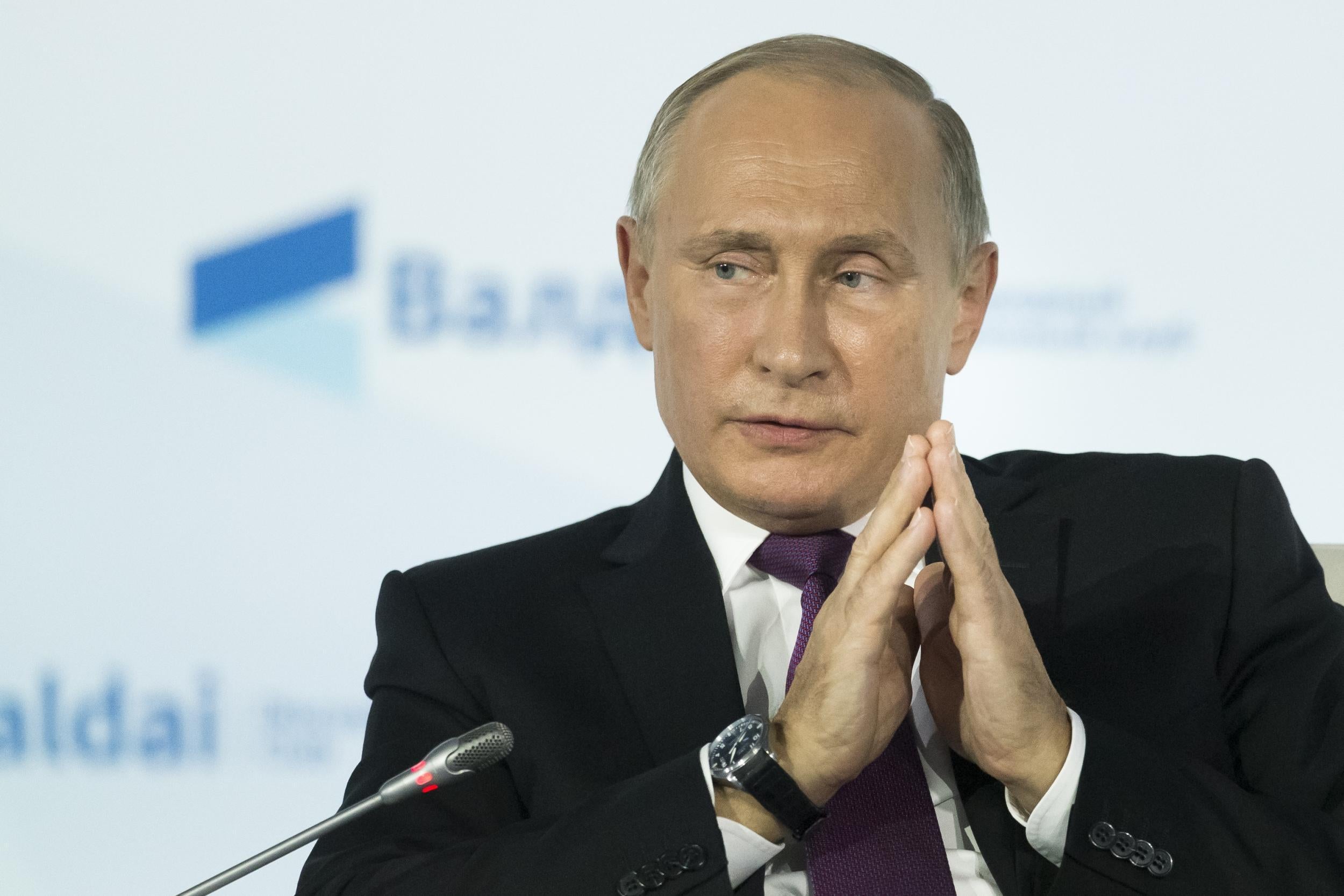 Russian President Vladimir Putin gestures as he speaks during the annual Valdai club conference of international experts in Sochi