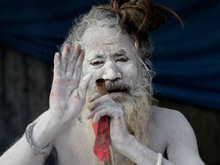Old Hairy Indian Man Drinking Tea At River Ganges 