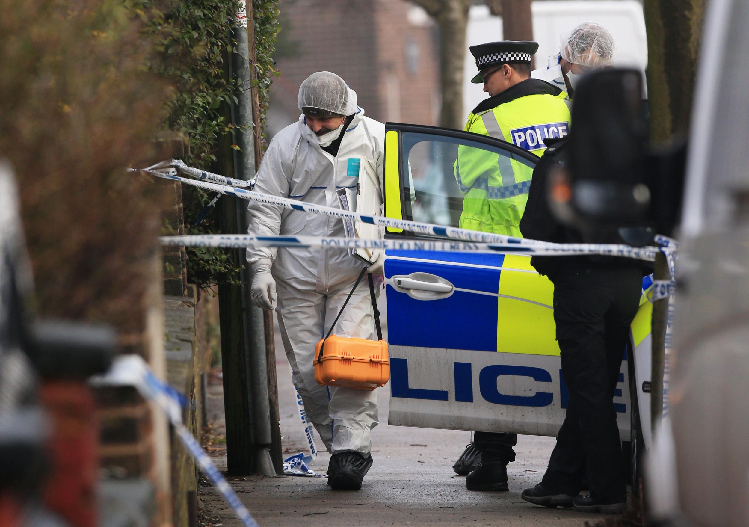 A forensics officer at the scene of a murder investigation in Matlock Road, Stockport