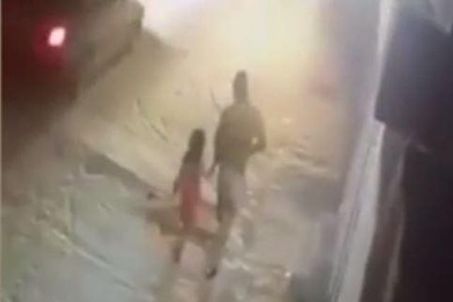 CCTV shows an unknown man leading Zainab Ansari away