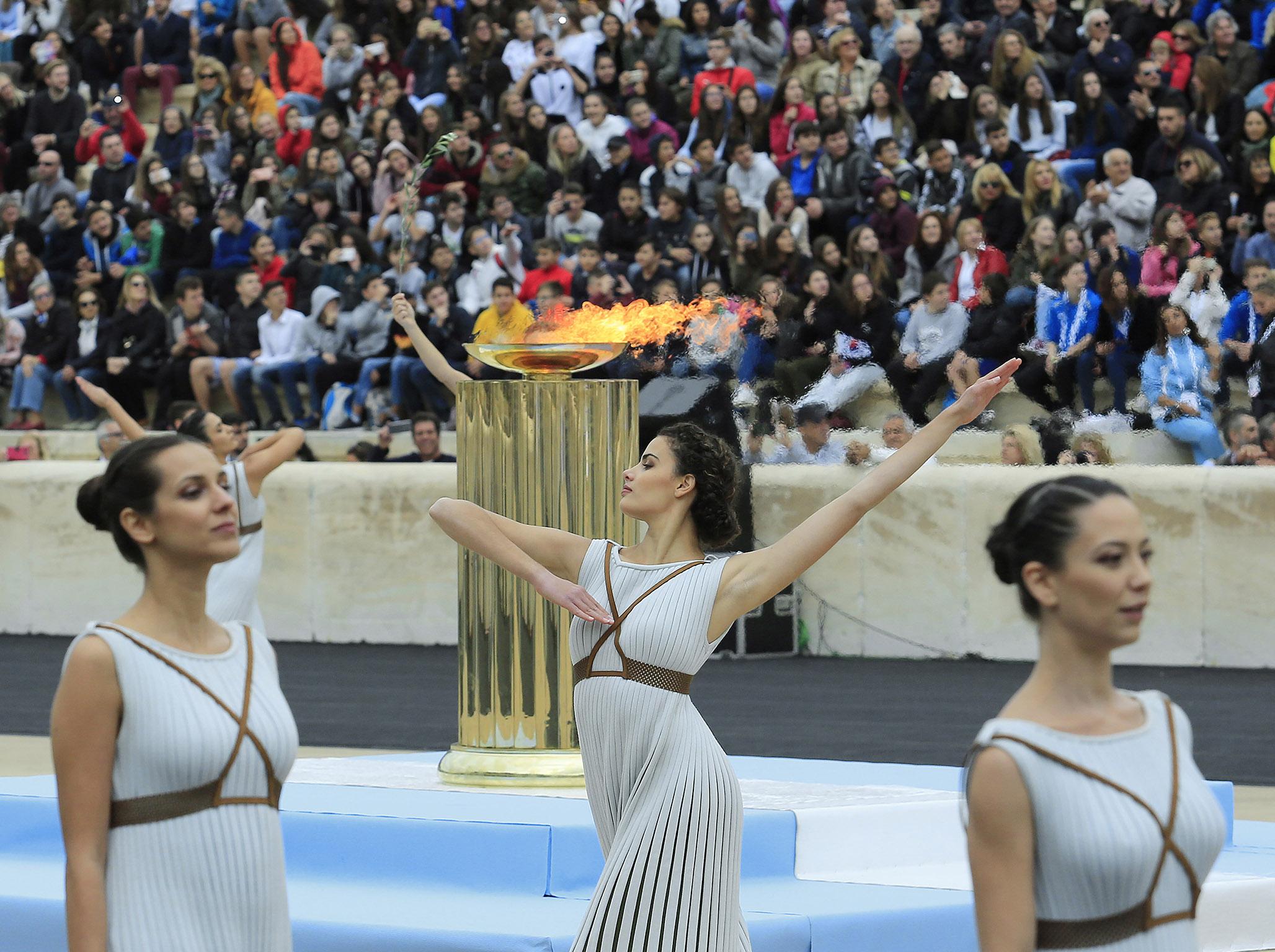 The Olympic flame was passed to South Korea in an Athens ceremony