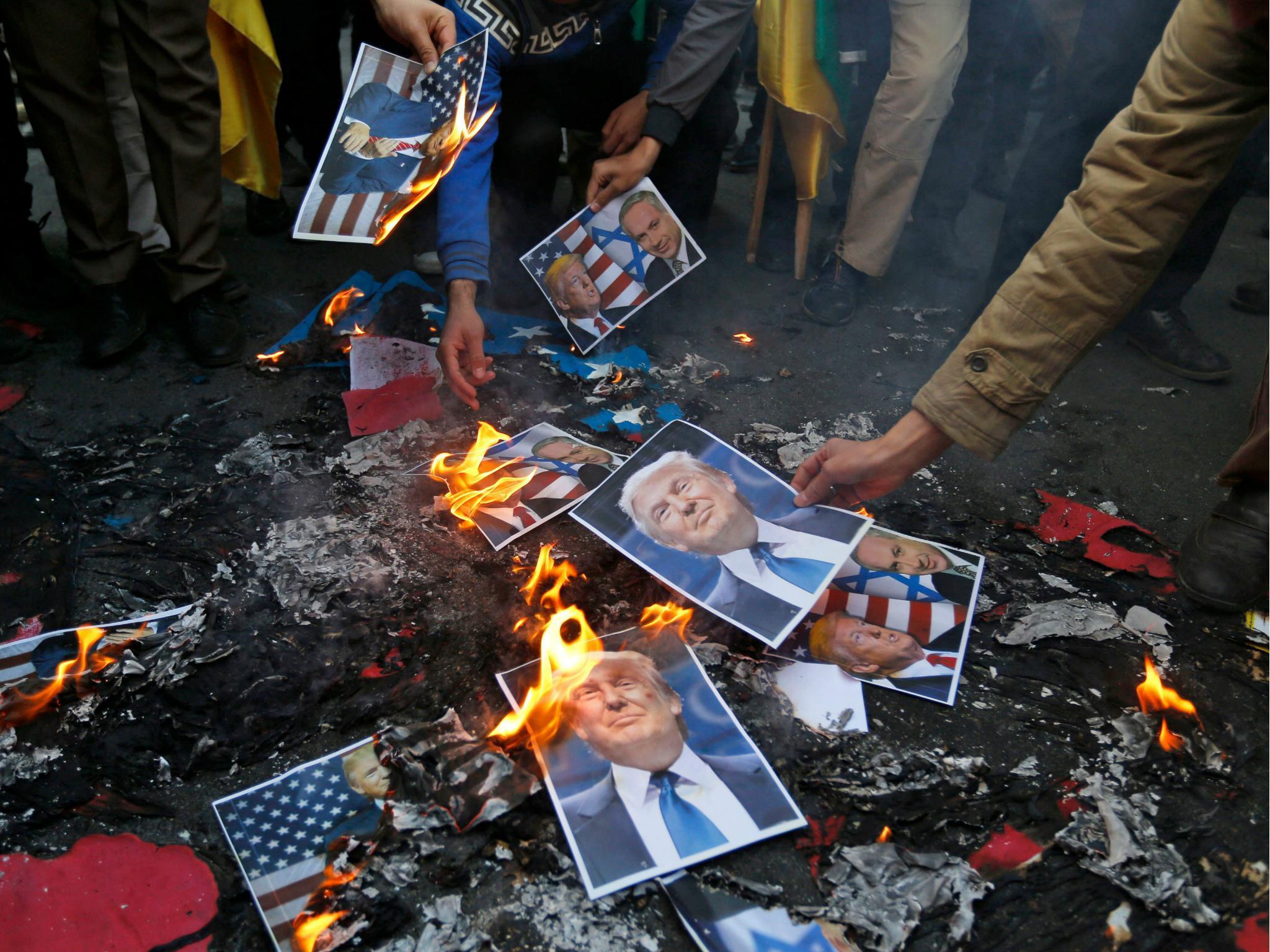 Portraits of the US President were burned during a demonstration in Tehran on 11 December