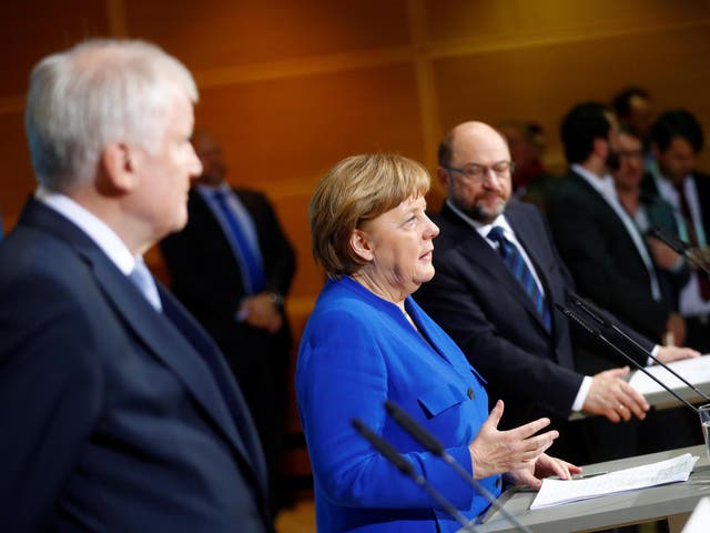 Acting German Chancellor Angela Merkel, leader of the Christian Social Union in Bavaria Horst Seehofer and Social Democratic Party leader Martin Schulz attend a news conference after exploratory talks about forming a new coalition government at the SPD headquarters in Berlin