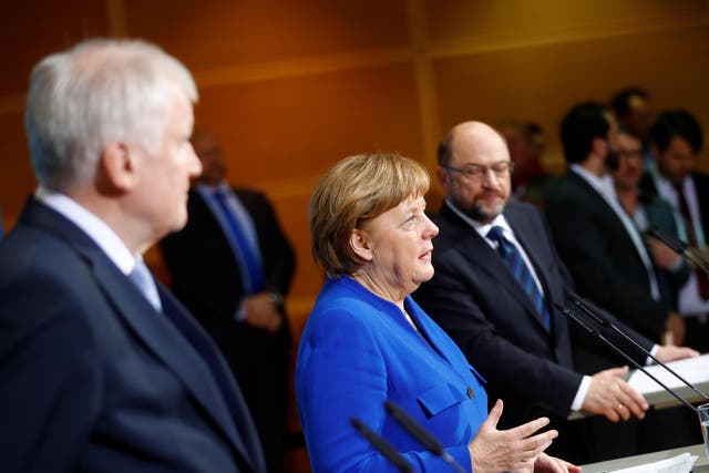 Acting German Chancellor Angela Merkel, leader of the Christian Social Union in Bavaria Horst Seehofer and Social Democratic Party leader Martin Schulz attend a news conference after exploratory talks about forming a new coalition government at the SPD headquarters in Berlin