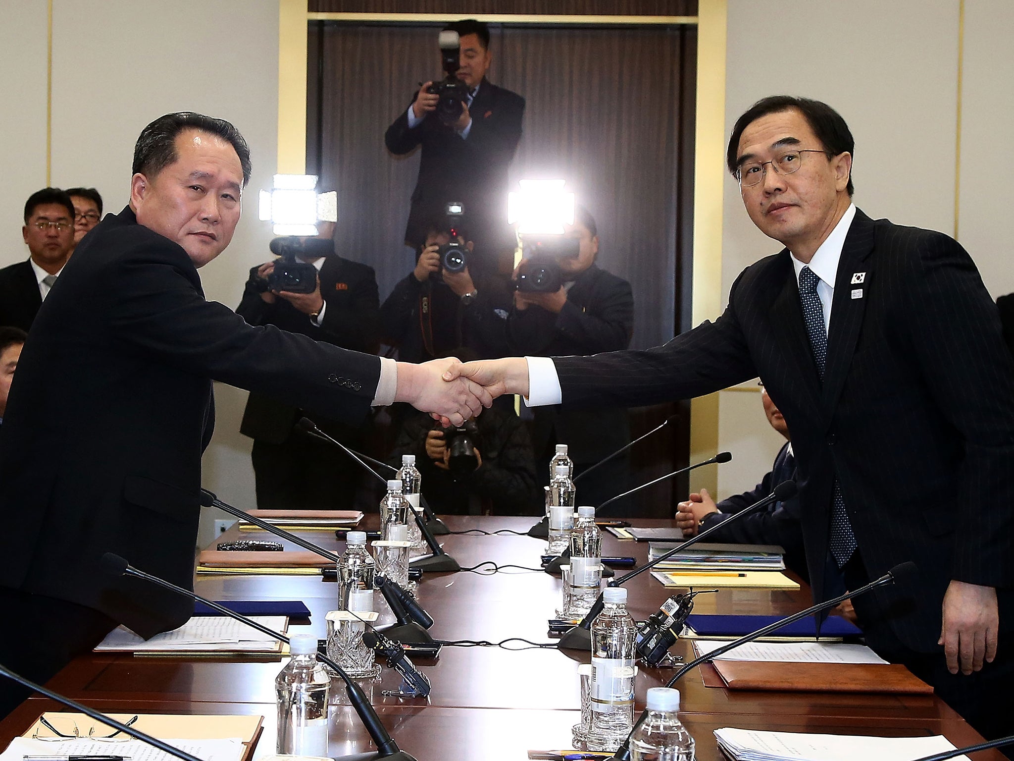 South Korean Unification Minister Cho Myoung-Gyon (R) shakes hands with the head of the North Korean delegation Ri Son-Gwon during talks this week