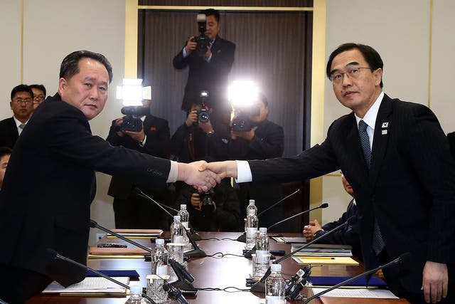 South Korean Unification Minister Cho Myoung-Gyon (R) shakes hands with the head of the North Korean delegation Ri Son-Gwon during talks this week