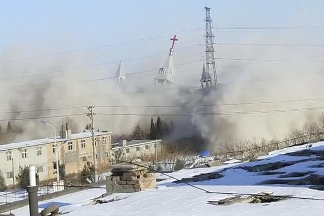 Clouds of debris billow during the demolition of the Golden Lampstand Church in Linfen