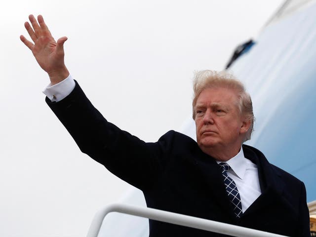 Donald Trump waves as he boards Air Force One upon departure from Joint Base Andrews in Maryland