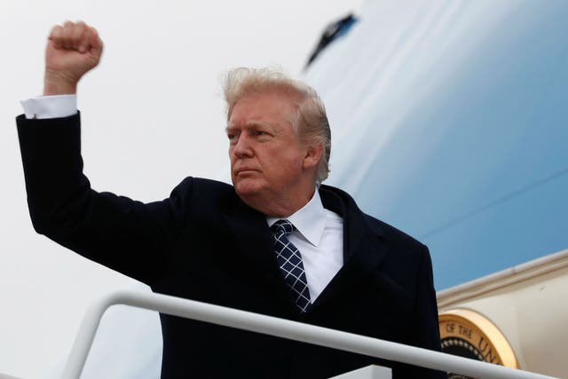 Donald Trump pumps his fist as he boards Air Force One upon departure from Joint Base Andrews