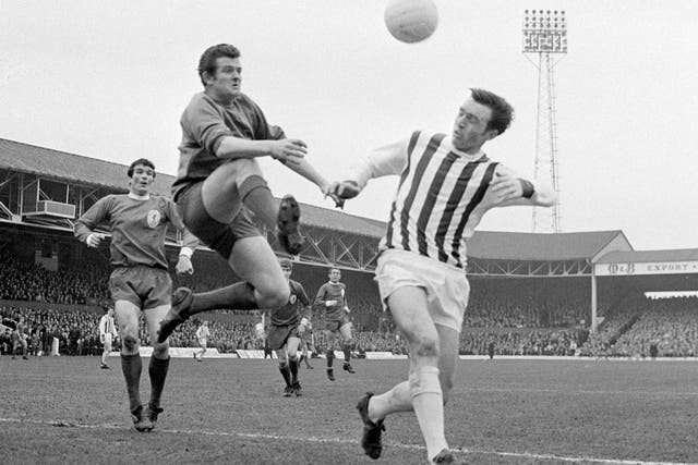 Former Liverpool and Scotland goalkeeper Tommy Lawrence ‘gallops’ through the air to beat West Bromwich Albion centre-forward Jeff Astle to the ball
