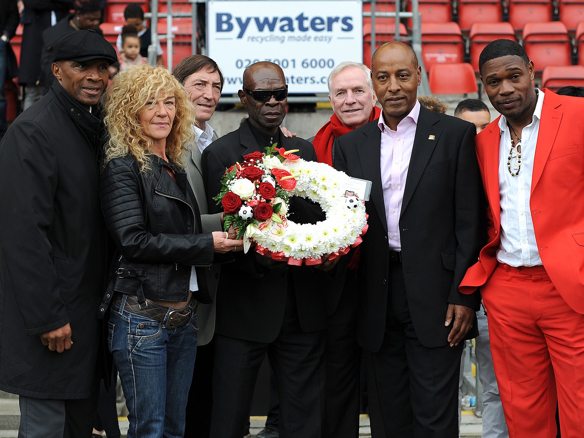 Regis (far left) attends a memorial service for his close friend Cunningham ahead of Leyton Orient vs MK Dons in 2013